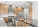 Modern kitchen with stainless steel appliances, large island, sleek countertops and bright wooden cabinets at 2236 Timber Rose Dr, Las Vegas, NV 89134