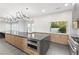 Modern kitchen with stainless steel appliances, large island, and sleek countertops and modern backsplash at 2236 Timber Rose Dr, Las Vegas, NV 89134