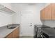 Bright laundry room features custom cabinets, folding counter, laundry sink, and washer/dryer at 2236 Timber Rose Dr, Las Vegas, NV 89134