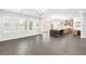 Expansive living area with open floor plan to modern kitchen with marble island, plus large windows at 2236 Timber Rose Dr, Las Vegas, NV 89134