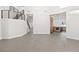 Bright, open-concept living space with modern staircase, sleek tile flooring, and view into the kitchen at 2236 Timber Rose Dr, Las Vegas, NV 89134