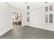 Bright, open-concept living space with modern staircase, sleek tile flooring, and view into the kitchen at 2236 Timber Rose Dr, Las Vegas, NV 89134