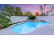 Backyard pool and spa with lush tropical landscaping and privacy wall at 2236 Timber Rose Dr, Las Vegas, NV 89134
