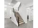 Staircase with modern metal handrails and light wood treads connecting the home's floors at 2236 Timber Rose Dr, Las Vegas, NV 89134