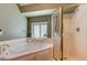 Elegant bathroom with large tub, shower, and window with plantation shutters at 2301 Jean Paul Ave, North Las Vegas, NV 89031