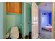 Bathroom featuring a toilet, vanity, mirror and an entry door with the view of a bedroom at 2301 Jean Paul Ave, North Las Vegas, NV 89031