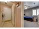 Bedroom featuring the view of a laundry room and a bed with dark wooden frame at 2301 Jean Paul Ave, North Las Vegas, NV 89031