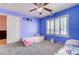 Comfortable bedroom with blue walls, carpeting, and plenty of natural light at 2301 Jean Paul Ave, North Las Vegas, NV 89031