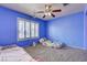 Bright bedroom with blue walls, large window, and comfortable sleeping space at 2301 Jean Paul Ave, North Las Vegas, NV 89031