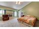 Cozy carpeted bedroom with fireplace, recliner, and comfortable queen bed at 2301 Jean Paul Ave, North Las Vegas, NV 89031