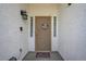 Close-up of the front door with a security gate and decorative details with a welcome sign at 2301 Jean Paul Ave, North Las Vegas, NV 89031