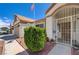 Welcoming front entrance featuring a security gate, decorative door, and charming landscaping at 2301 Jean Paul Ave, North Las Vegas, NV 89031