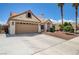 Charming single-story home featuring a two-car garage, landscaped front yard, and an American flag at 2301 Jean Paul Ave, North Las Vegas, NV 89031