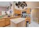 Kitchen featuring wooden cabinets, pot rack, tile floors, and a central island at 2301 Jean Paul Ave, North Las Vegas, NV 89031