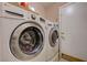 Bright laundry area featuring a front-load washer and dryer set for convenient chores at 2301 Jean Paul Ave, North Las Vegas, NV 89031