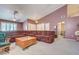 Spacious living room features a large brown couch and a light brown wood coffee table at 2301 Jean Paul Ave, North Las Vegas, NV 89031