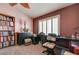 Bright home office with natural light, a bookcase, a desk, and a comfortable chair at 2301 Jean Paul Ave, North Las Vegas, NV 89031