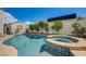 Beautiful in-ground pool with an attached jacuzzi surrounded by landscaped greenery at 2301 Jean Paul Ave, North Las Vegas, NV 89031
