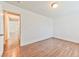 Spacious bedroom showcasing laminate flooring and a view into the hallway at 2323 Mariposa Ave, Las Vegas, NV 89104