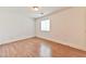 Cozy bedroom with laminate flooring, a window with blinds, and neutral walls at 2323 Mariposa Ave, Las Vegas, NV 89104