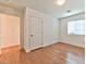 A light filled bedroom featuring a window, white trim, and laminate flooring at 2323 Mariposa Ave, Las Vegas, NV 89104