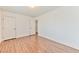 A well-lit bedroom featuring laminate floors, neutral walls, and closet access at 2323 Mariposa Ave, Las Vegas, NV 89104