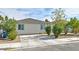 Charming single-story home featuring a concrete driveway, neat landscaping, and a welcoming facade at 2323 Mariposa Ave, Las Vegas, NV 89104