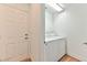 Functional laundry area equipped with a washer, dryer, and a nearby doorway at 2323 Mariposa Ave, Las Vegas, NV 89104
