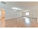 Large living area with wood floors, ample natural light, and a modern lighting fixture at 2323 Mariposa Ave, Las Vegas, NV 89104
