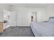 Carpeted bedroom with ensuite bathroom and open doorway to a separate living area at 2421 Gamma Ray Pl, Henderson, NV 89044