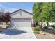 Charming single-story home featuring a well-maintained front yard and a two-car garage in a residential neighborhood at 2421 Gamma Ray Pl, Henderson, NV 89044