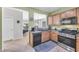 Functional kitchen with stainless steel appliances, wooden cabinets, and open access to the living areas at 2421 Gamma Ray Pl, Henderson, NV 89044
