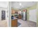 Well-lit kitchen with wooden cabinetry, stainless steel appliances, and an open layout to adjacent rooms at 2421 Gamma Ray Pl, Henderson, NV 89044