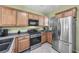 Modern kitchen featuring stainless steel appliances, oak cabinetry, and plenty of counter space at 2421 Gamma Ray Pl, Henderson, NV 89044