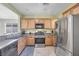 Well-lit kitchen features stainless steel appliances, wood cabinetry, and granite countertops at 2421 Gamma Ray Pl, Henderson, NV 89044