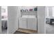 Convenient laundry room with a washer and dryer, plus shelving for storage of laundry supplies at 2421 Gamma Ray Pl, Henderson, NV 89044