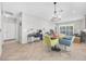Bright living and dining space with a desk area, modern lighting, and seamless flow between rooms at 2421 Gamma Ray Pl, Henderson, NV 89044