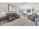 Spacious living room with plush carpeting, comfortable seating, and natural light from the windows at 2421 Gamma Ray Pl, Henderson, NV 89044