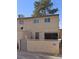 Two-story home featuring a neutral tan exterior, a functional satellite dish and a simple front-facing facade at 2525 Donna St # L, North Las Vegas, NV 89030