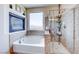 Bright bathroom featuring a shower, tub, and stylish fixtures, creating a modern and inviting space at 2733 Auchmull St, Henderson, NV 89044