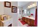 Well-lit bathroom features double sinks with a large vanity, and decorative framed artwork on the walls at 2733 Auchmull St, Henderson, NV 89044