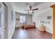 Cozy bedroom with hardwood floors, a daybed, ceiling fan, and a bright window, creating a welcoming atmosphere at 2733 Auchmull St, Henderson, NV 89044