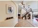 Spacious foyer with tile flooring, stairs and views into the formal dining and other living spaces at 2733 Auchmull St, Henderson, NV 89044