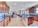 Open-concept layout featuring a kitchen island, wood cabinets, and seamless transition to the living area at 2733 Auchmull St, Henderson, NV 89044