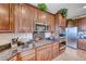 A well-equipped kitchen features granite countertops, stainless steel appliances, and ample cabinet space at 2733 Auchmull St, Henderson, NV 89044