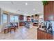 Eat-in kitchen featuring dark wood cabinets, granite countertops, island seating, and modern appliances at 2733 Auchmull St, Henderson, NV 89044