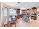 An inviting kitchen area with stainless appliances, center island with seating, and a cozy dining space at 2733 Auchmull St, Henderson, NV 89044