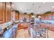 Spacious kitchen with dark wood cabinets, granite counters, stainless steel appliances, and island seating at 2733 Auchmull St, Henderson, NV 89044
