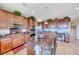 A gourmet kitchen with wooden cabinets, granite counters, stainless appliances, and island seating at 2733 Auchmull St, Henderson, NV 89044