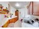 Well-lit laundry room featuring tile floors, wooden cabinets, a utility sink, and modern washing machine at 2733 Auchmull St, Henderson, NV 89044